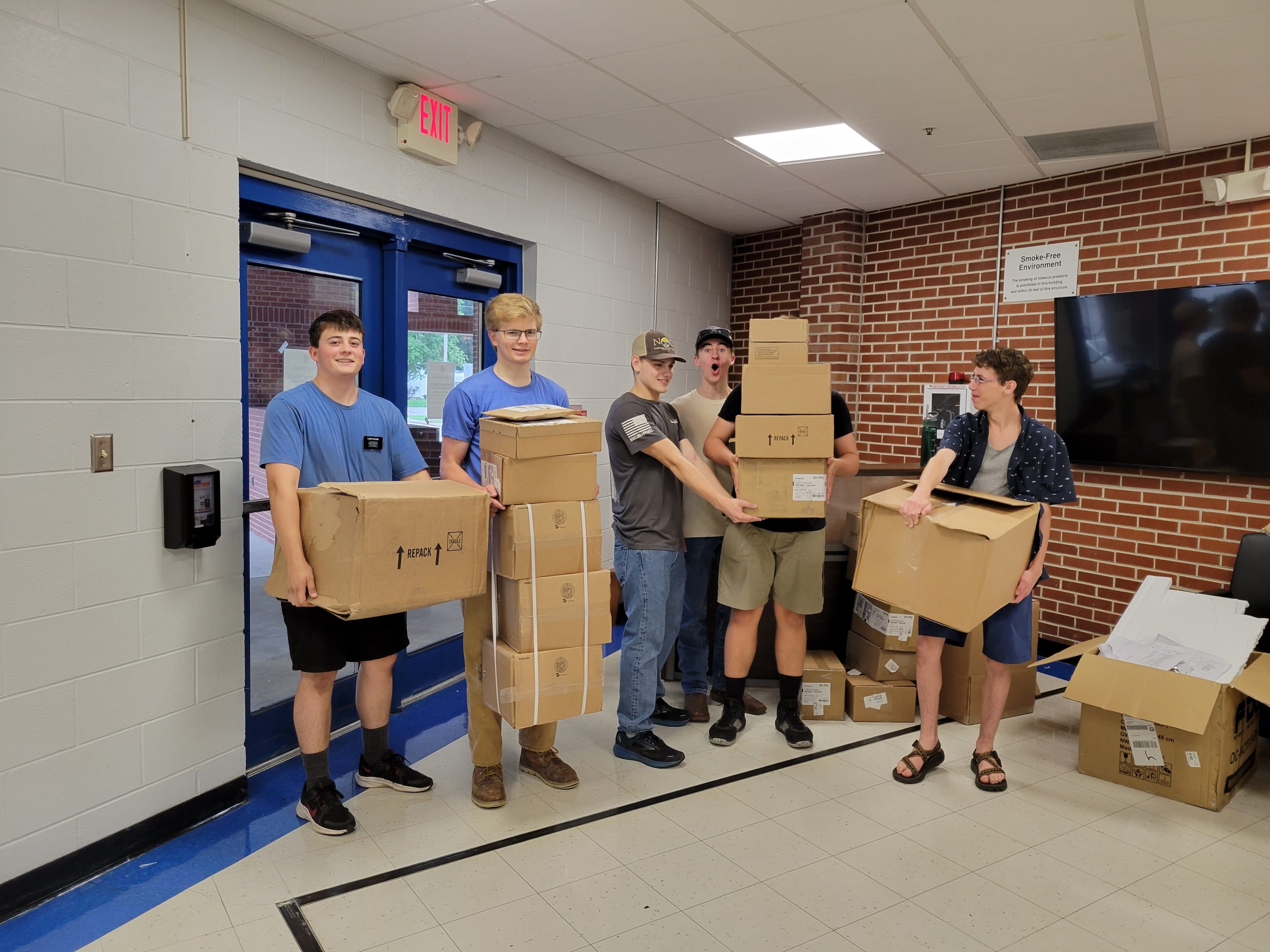Students carry boxes