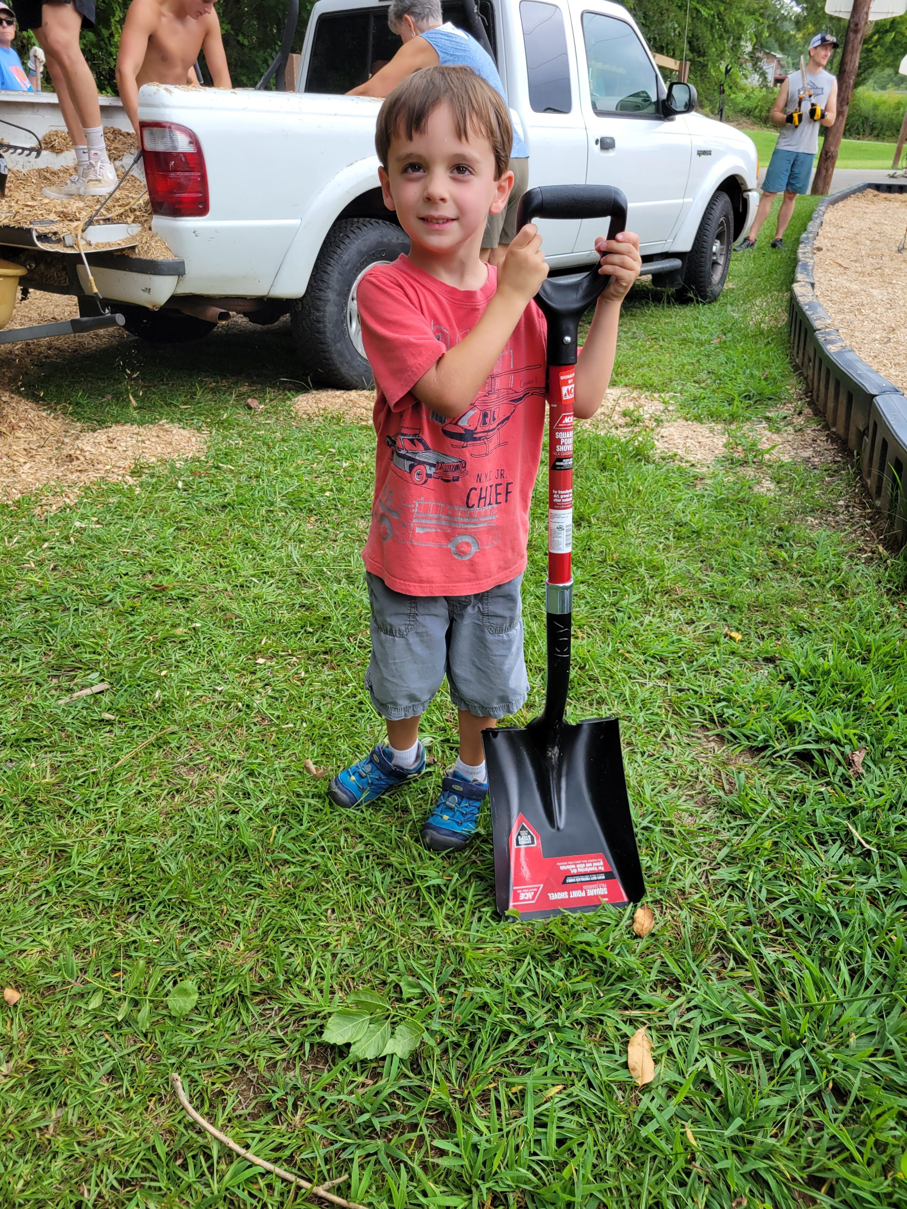 A child holds a shovel