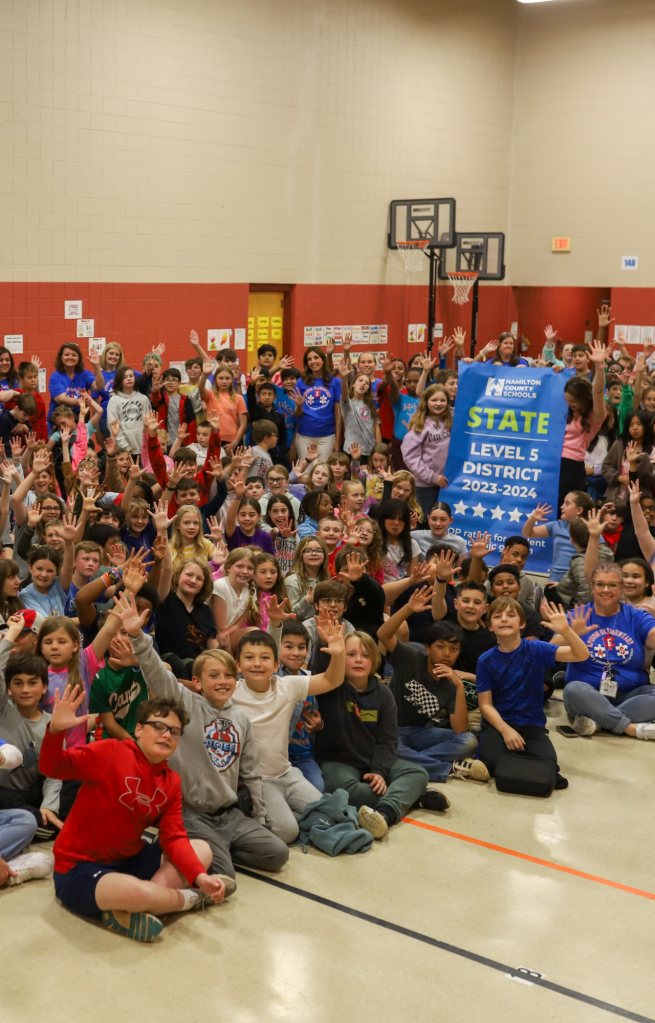 Students pose for a banner presentation photo