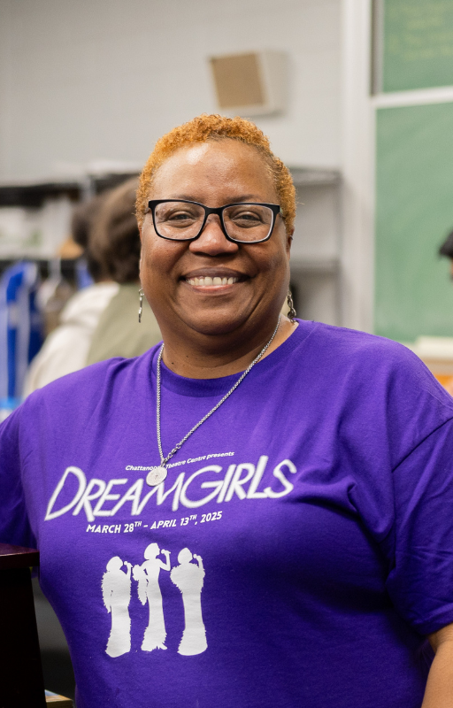 A teacher poses for a photo
