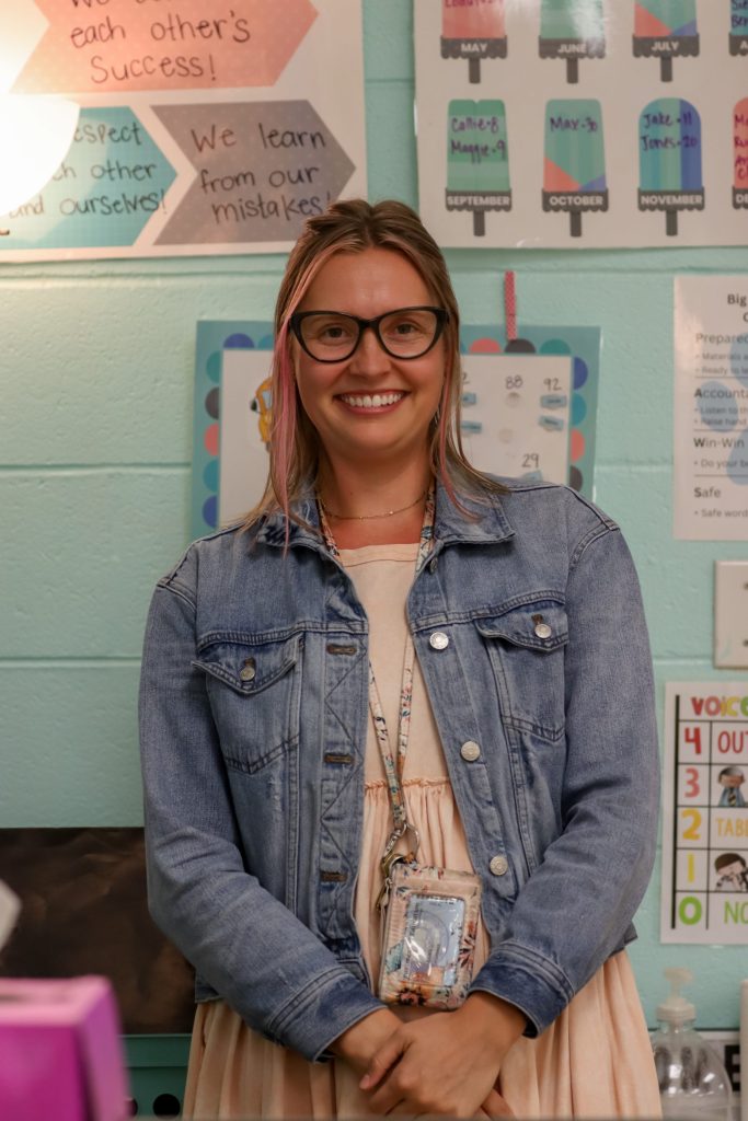 A teacher poses for a photo