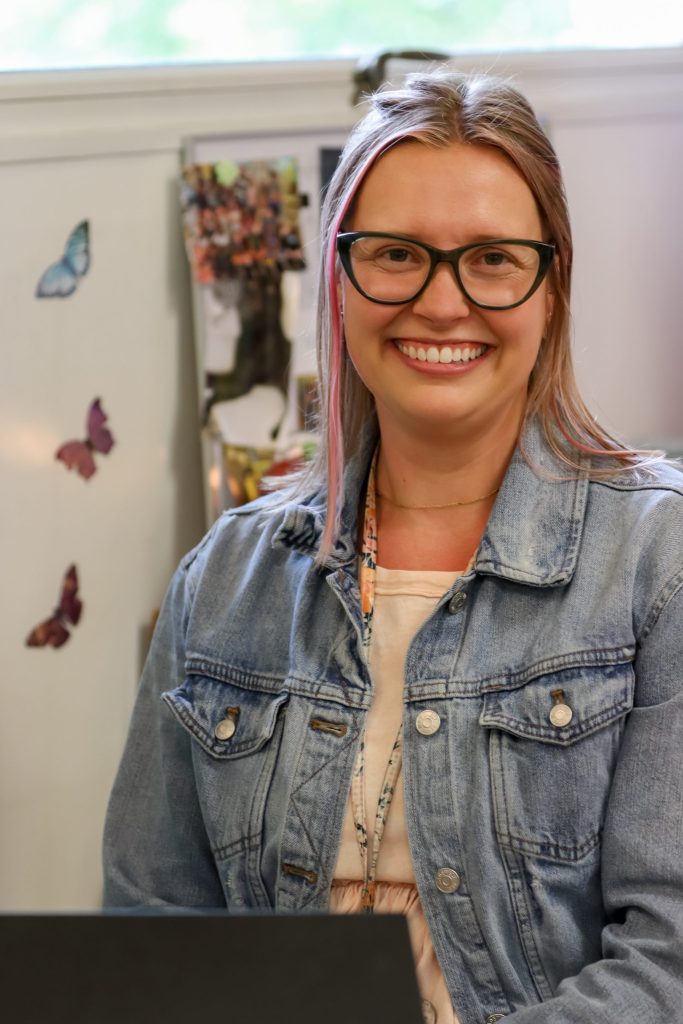A teacher poses for a photo