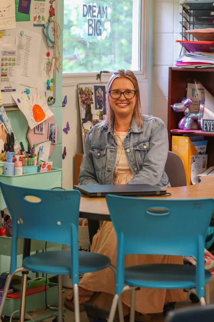 A teacher poses for a photo
