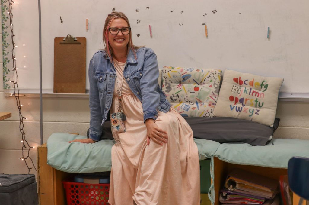 A teacher poses for a photo