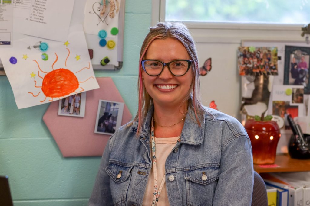 A teacher poses for a photo
