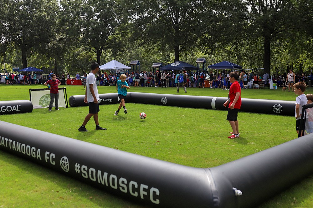kids playing soccer outside at back to school bash