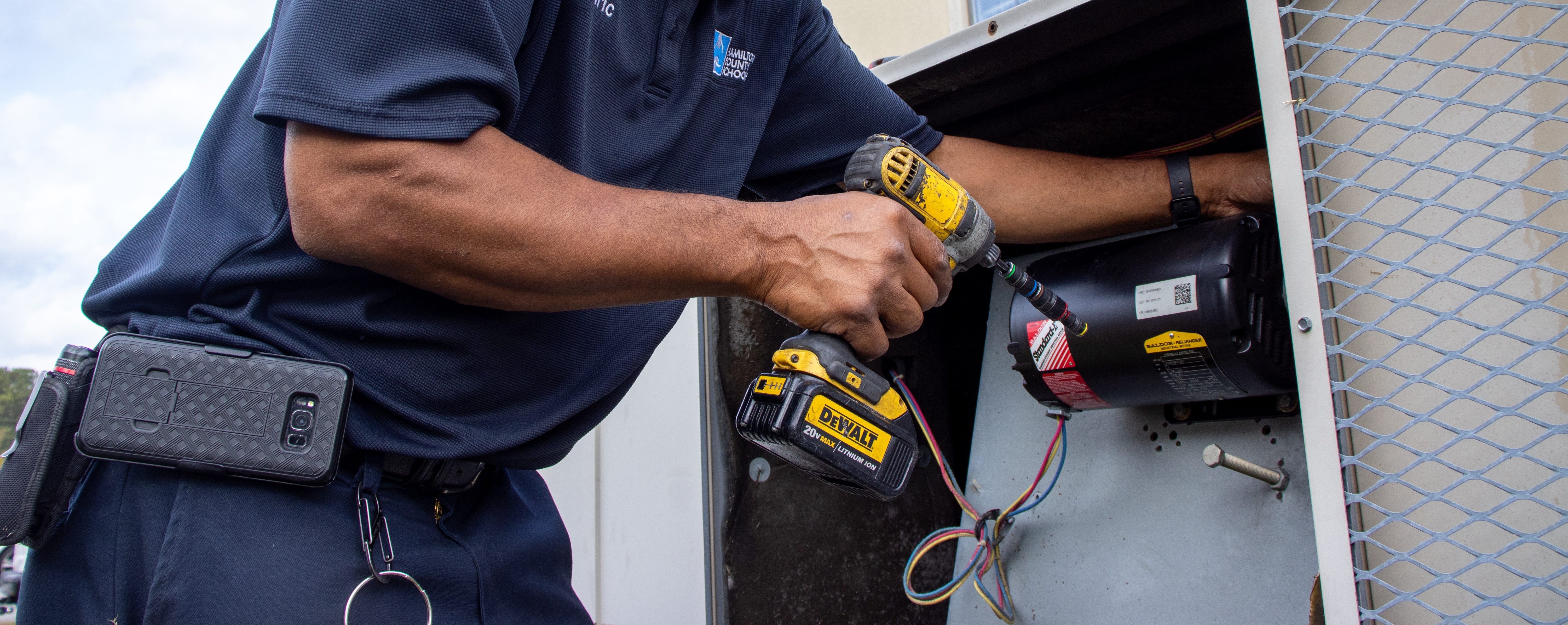 A maintenance worker uses a tool