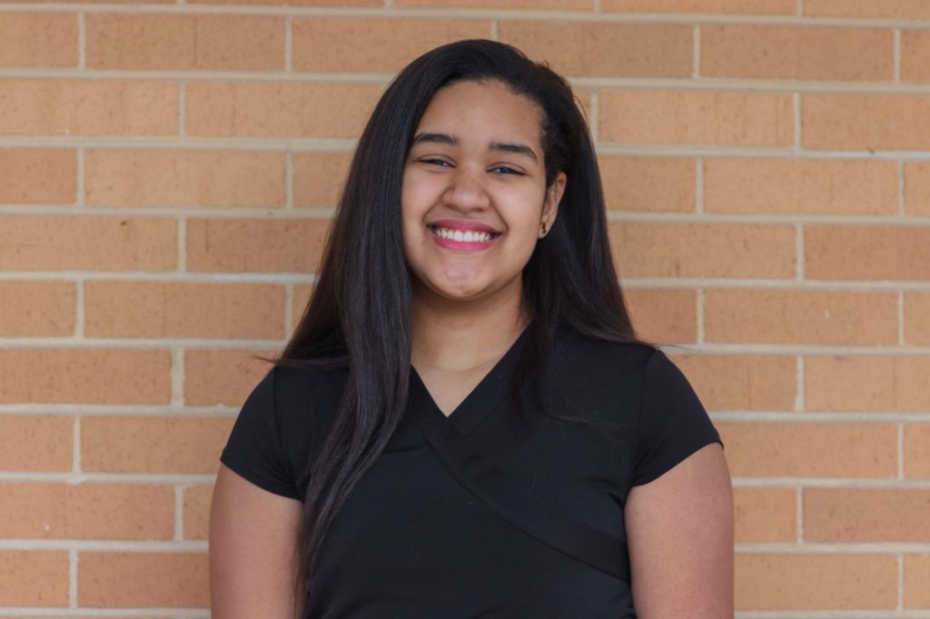 A student smiles for a photo