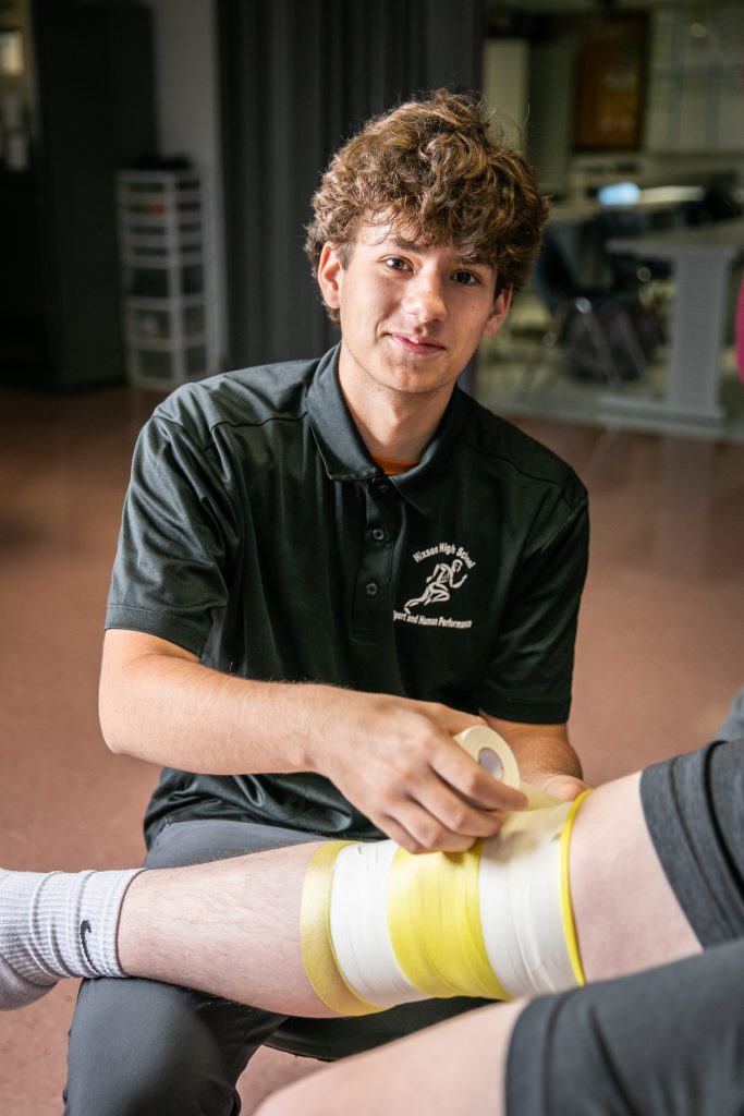 students practice wrapping leg