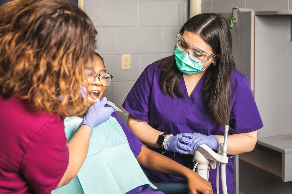 students practice dental exam