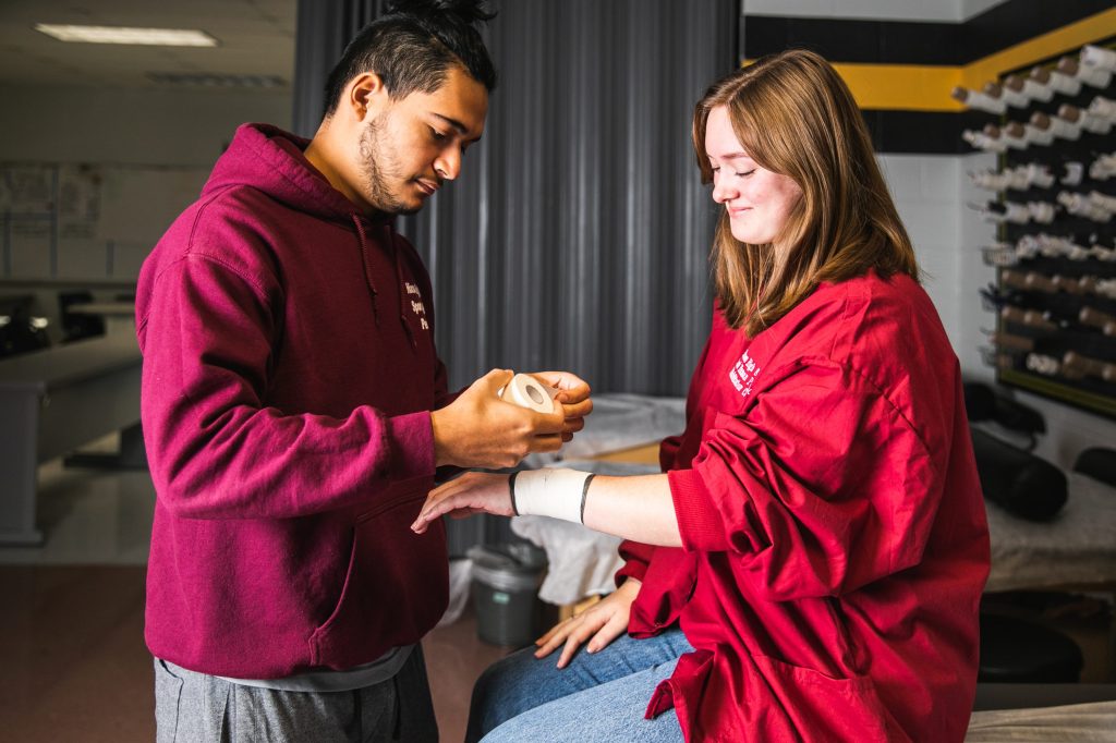 students practice wrapping arm