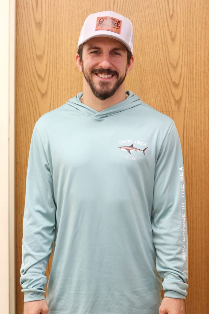 A teacher poses for a photo