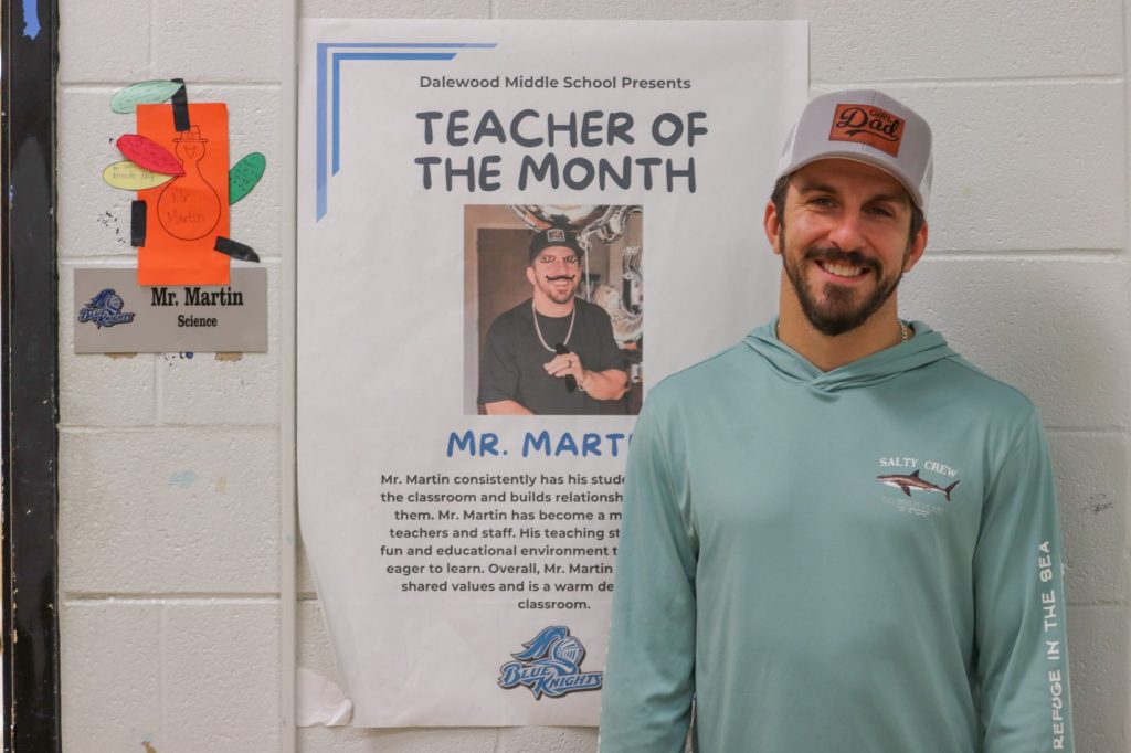 A teacher poses for a photo