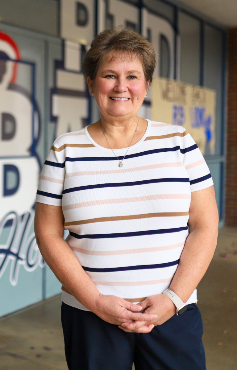 A teacher smiles
