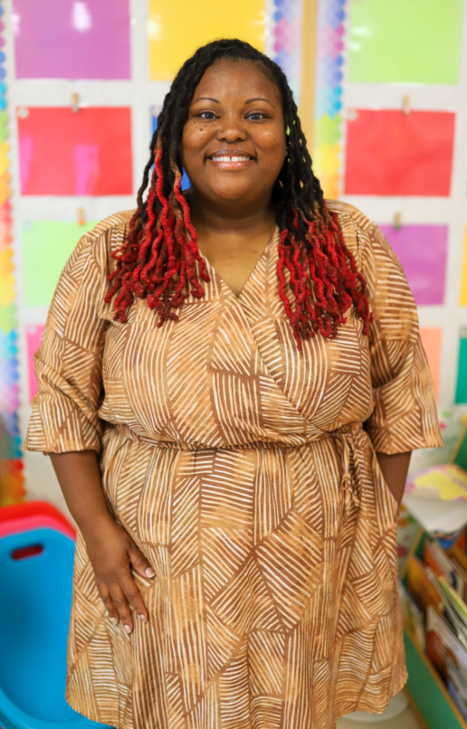 A teacher poses for a photo