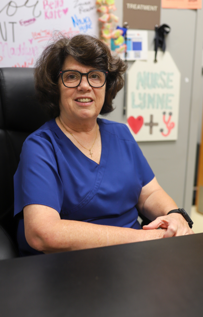 A nurse poses for a photo