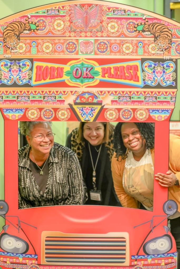 Three people smile for a photo