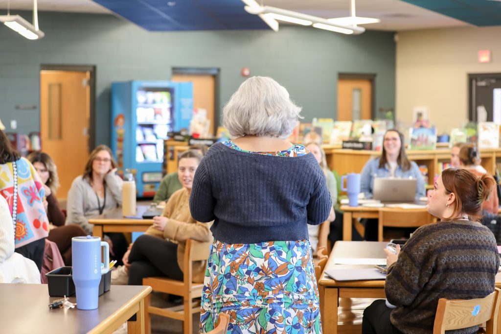A woman speaks to a room