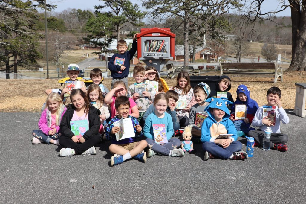 Students pose with books