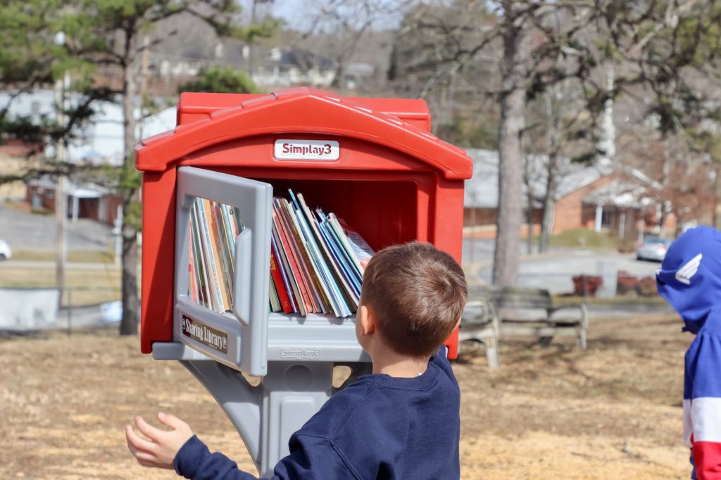 A student reaches for a book