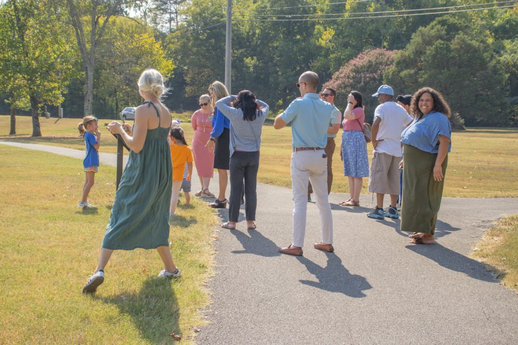 students, staff, community members, and families on story book trail
