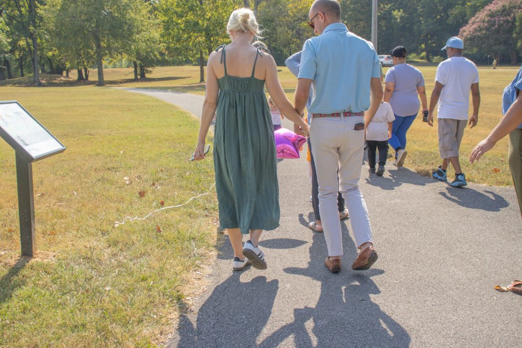 students, staff, community members, and families on story book trail