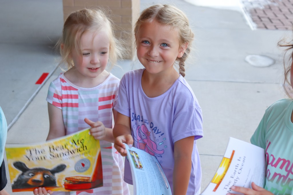 smiling student holding book