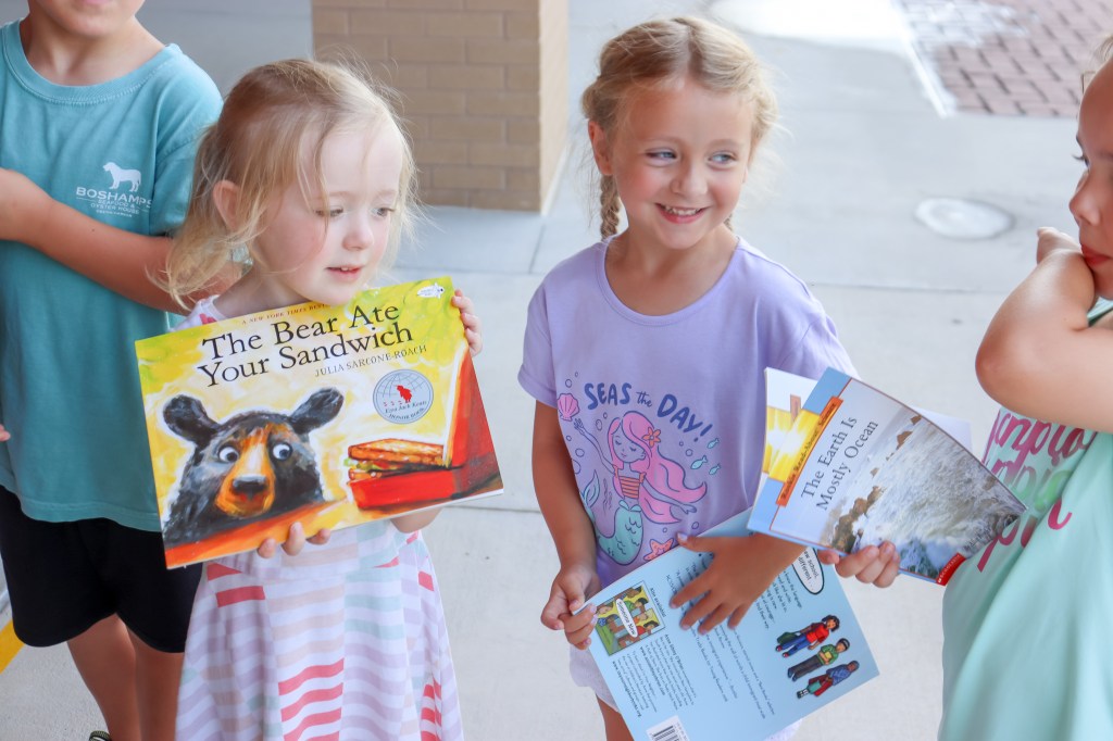 smiling student holding book