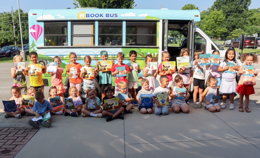 smiling students holding books