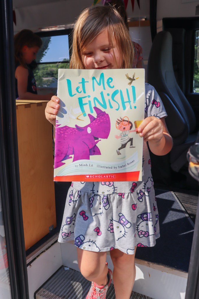 smiling student holding book