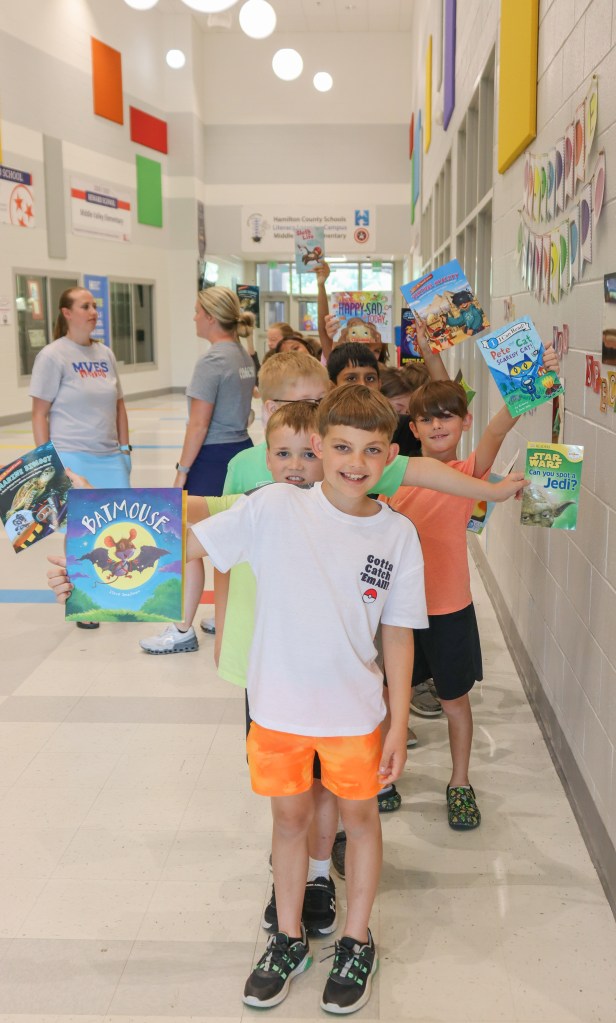 students holding books