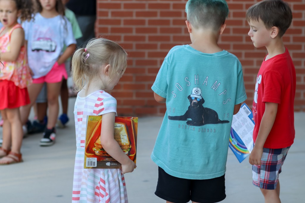 students looking at book