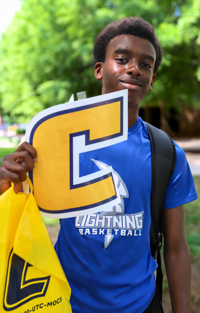 student posing for picture and smiling outside
