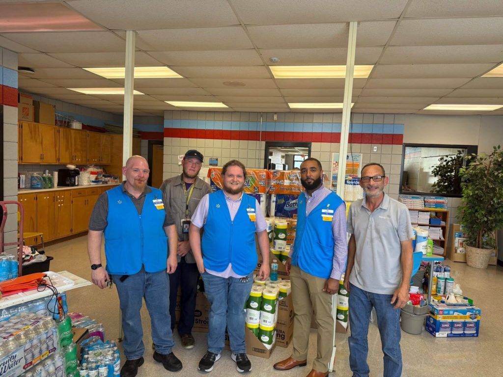 IMG_0716 Workers pose for a photo with supplies